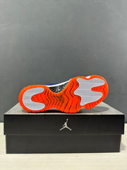 Bottom view showing the orange rubber outsole, white traction inserts, and central black textured section.