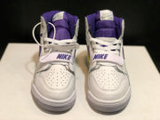 Front view of the pair showing the white perforated toe boxes, purple tongues, white laces, and midfoot straps.