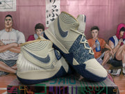 Angled display of the off-white and navy basketball sneakers showing the high-top collar, lace-up design, side branding, and textured outsole.