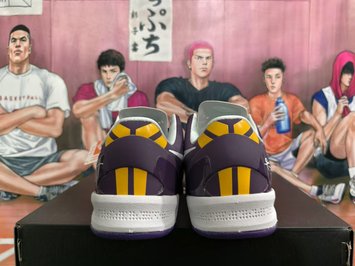 Rear view of purple basketball shoes with yellow heel accents and white midsoles