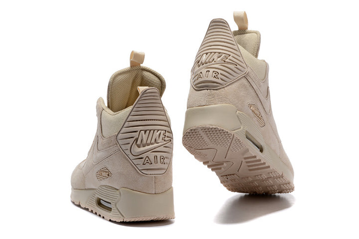 Pair of light beige Nike Air Max 90 Winter high-top sneakerboots shown from the rear and outsole.