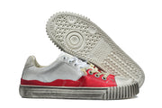 Low-top sneaker side view beside its patterned outsole