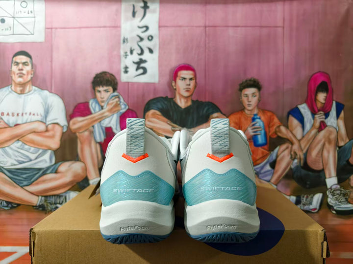 Rear view of white basketball shoes showing pale blue heel panels, coral accents, and Swiftace text.