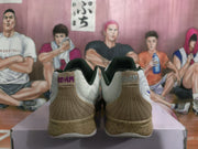 Rear view showing tan heel panels, dark collars, JA heel branding and speckled soles.