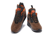 Front views of brown Nike Air Max 90 Winter Sneakerboot high-tops with orange lining and black laces.