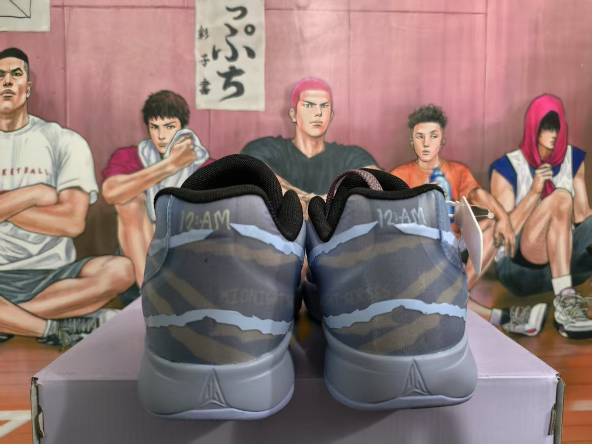 Rear view of blue-gray Nike sneakers showing padded collars, patterned uppers, and light-gray heel sections.