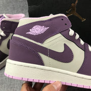Close-up of the Air Jordan Wings branding, purple Swoosh, and stitched side panels.