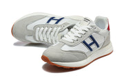 Pair of grey and white lace-up sneakers shown from above and at an angle.