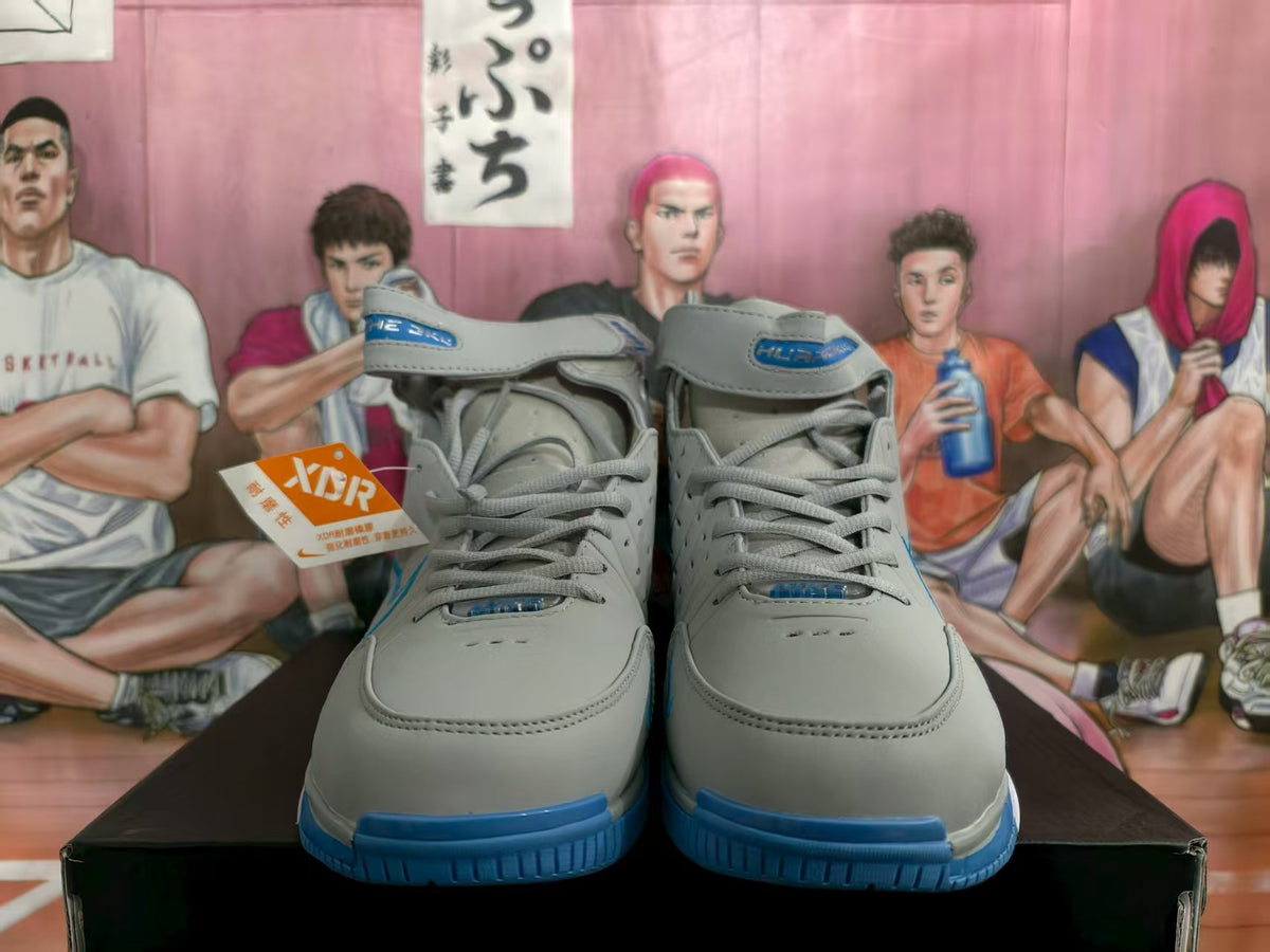 Front view of gray and blue Nike high-top basketball sneakers with ankle straps and blue outsoles