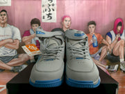 Front view of gray and blue Nike high-top basketball sneakers with ankle straps and blue outsoles