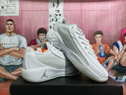 Angled view of the sneakers showing the mesh-textured side panels, layered white midsole, and side Jumpman logo.