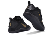 Black and gold basketball shoes shown from the heel and outsole