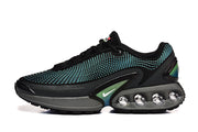 Side view of black sneakers with turquoise detailing and visible circular midsole elements