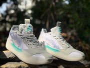 Front three-quarter view of the pair with gray laces, patterned tongues, and teal details.