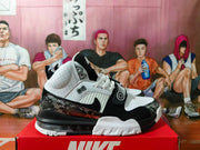 Side view highlighting the shoe's midfoot strap, patterned overlays, and heel cushioning unit.