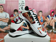 Pair of white basketball sneakers shown from angled side and top views, featuring black laces and multicolored graphic panels.