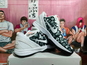 Angled view of the paired Nike basketball sneakers showing the patterned uppers, white midsoles, and black outsoles.