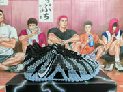 Side view of a black and gray Nike basketball shoe showing the patterned upper, Swoosh and sculpted outsole