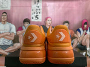 Rear view of the sneaker pair showing the star-and-chevron heel emblems and layered heel construction.