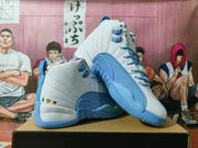 Angled view of a pair of white and blue high-top Jordan sneakers with colorful heel accents.