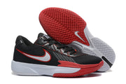Angled view of the black and red basketball shoes with the textured red outsole prominently visible.