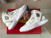 Angled top-down view of the white sneaker pair showing the side panels, swoosh-style marks, and white soles.