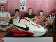 Side view of white Nike basketball sneakers with black Swooshes, red midsoles, and olive heel panels on a shoe box.