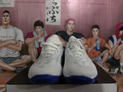 Front view of the white Nike basketball-style sneakers with white laces, blue outsole edges and translucent upper details.