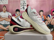 Pair of white Kai basketball shoes shown from the side, featuring red accents and a contrasting heel panel.