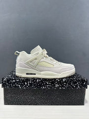 Side profile of white and light grey Jordan Spizike sneakers displayed on a patterned shoebox.