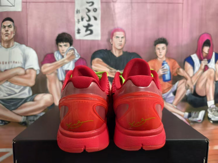 Rear view of red Nike Zoom basketball sneakers showing padded collars, translucent heel details and green accent elements.