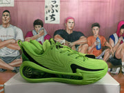 Side profile of a green basketball sneaker showing its low-top shape, black side accent, and sculpted outsole.