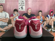 Rear view of the pink basketball sneakers showing burgundy heel panels, pale pink overlays, and heel branding details.