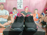 Front view of the pair showing black laces, pink tongue details, and black textured outsoles.