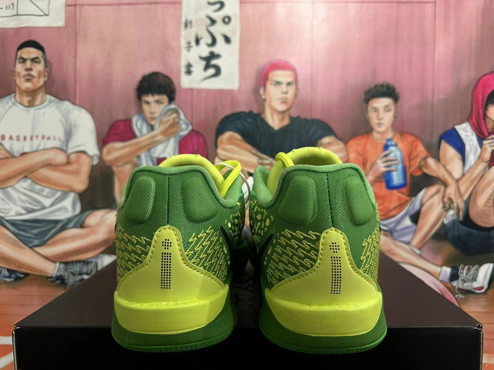 Rear view of green Nike basketball shoes with bright yellow-green heel accents.