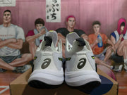 Rear view of white ASICS shoes showing heel logos, pull tabs, and black outsoles.