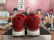 Rear view of red and white Nike sneakers showing the heels and light-colored midsoles