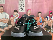 Front view of black Adidas shoes with white stripe details and light-colored toe outsoles.