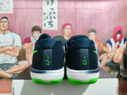 Rear view of the shoes with green heel lettering and bright green outsole accents.