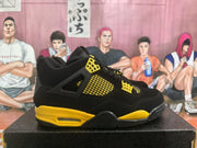 Side view of a black and yellow high-top sneaker showing the mesh side panel and layered midsole.