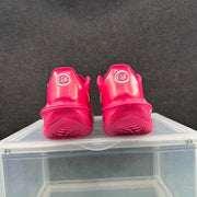 Rear view of a pair of bright pink basketball sneakers showing GT heel badges and textured outsoles.