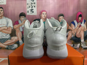 Rear view of white high-top Nike basketball shoes with gray accents