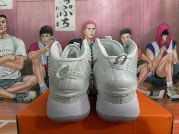 Rear view of white high-top Nike basketball shoes with gray accents