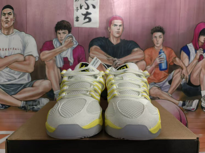 Front view of white and yellow Nike basketball shoes