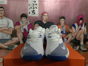 Front view showing the white laces, textured toe panels, Nike branding, and blue rubber outsoles.