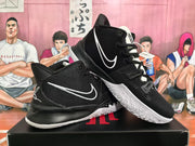 Angled view of a pair of black and white Nike basketball sneakers displaying the side Swoosh, lace system, heel detailing, and patterned outsole.