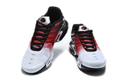 Pair of Nike Air Max Plus sneakers viewed from the front, with white toes, red panels, and black laces.