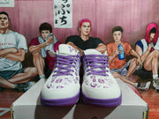 Front view showing the paired purple and white sneakers with purple laces and printed upper details.