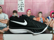 Side profile of a black basketball shoe with white outsole, Swoosh logo, and AIR ZOOM lettering
