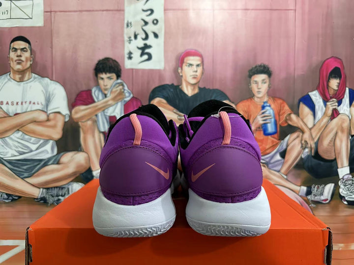 Rear view of black and purple Nike basketball shoes with white soles and pink heel accents
